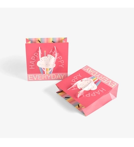 Close-up of pink gift bags with cupcakes and HAPPY EVERYDAY text for bakery
