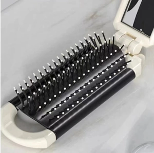 Portable folding hair brush with mirror in cream white for travel and daily use