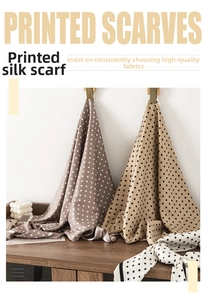 Detail of French beige polka dot large square silk scarves hanging on display