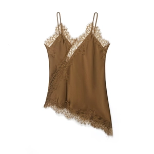 Detail of satin camisole with lace trim, V-neckline and irregular asymmetric hem