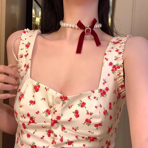 Elegant pearl choker necklace with a red velvet bow and gemstone for women