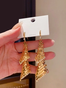 Detailed view of 18k gold plated mesh fringe earrings with shimmering zircon accents