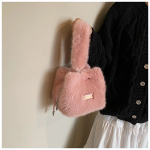 Pink plush bucket bag with lovely day tag and silver chain worn by a woman