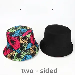 Reversible bucket hat with vibrant tropical palm tree print and solid black design