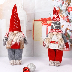 Standing Christmas gnome dolls with red hats and white beards in festive holiday decor