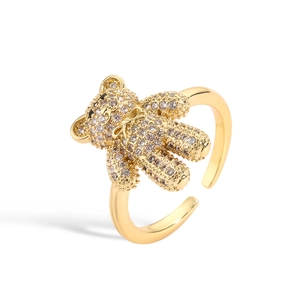 Detail of a gold-plated open ring featuring a cute bear design with colorful pavé crystals