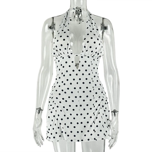 Detailed view of the halter neck tie and deep V-neckline on the polka dot dress