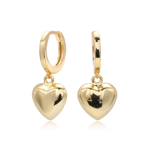 Detail shot of golden S925 sterling silver heart drop earrings with a polished finish