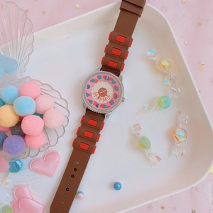 Detailed view of pink quartz watch dial with biscuit pattern and brown silicone strap