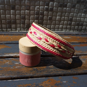 Detailed weave of handmade raffia headband with pink accents for beach vacations