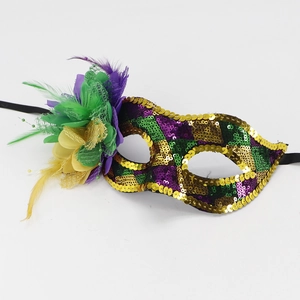 Detailed shot of Mardi Gras mask featuring vibrant purple, green, and gold sequins with feathers