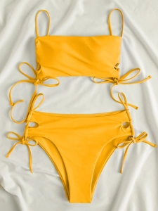 Detail of yellow bikini set with side drawstring ties and ribbed fabric texture