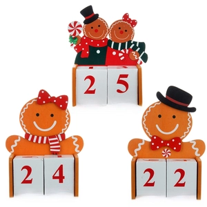 Three wooden gingerbread man Christmas advent calendars showing countdown dates