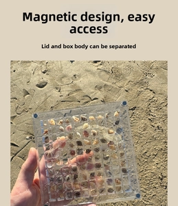 Detail of magnetic acrylic box with multi-grid design for shell collection on sand