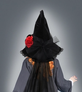 Back view of a black velvet witch hat featuring red roses and long trailing mesh veil