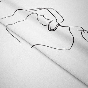 Close-up of minimalist white fabric tapestry with black abstract line art portrait