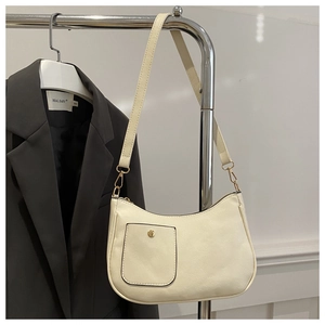 Close-up of a beige PU leather shoulder bag with a rectangular pocket and metal snap button