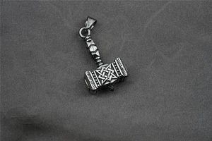 Detailed macro shot of vintage Mjolnir Thor's hammer pendant in durable titanium steel