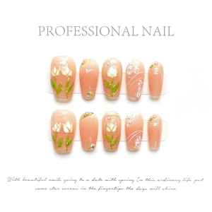 Detail of pink gradient press-on nails with hand-painted white tulips and pearls