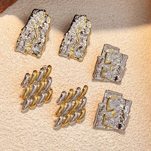 Mixed metal wrinkled stud earrings in gold and silver with textured vintage style
