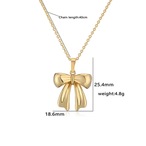 Detail view of the gold bow necklace dimensions including length 40cm and pendant size