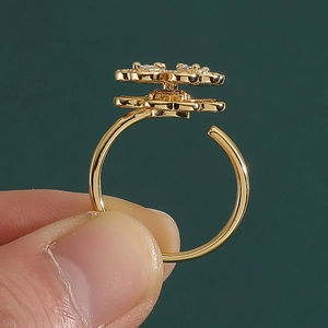 Close-up of a rotating golden open ring featuring double-layer flower and crystal petals
