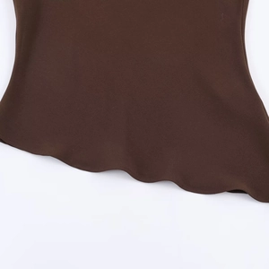 Dark brown top with asymmetrical wavy ruffled hemline shown in detailed flat lay view