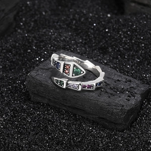 S925 sterling silver snake ring with colorful zircons on a dark charcoal background