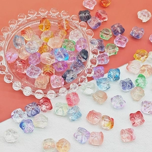 Colorful cat-shaped translucent resin beads scattered on an embossed glass plate