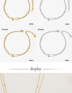 Detail of gold and silver stainless steel star and pearl necklace and bracelet set