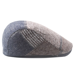 Close-up of patchwork newsboy cap with herringbone and denim textures in vintage style