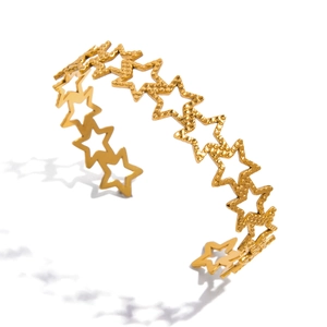 Gold stainless steel open bangle with hammered texture and hollow star design