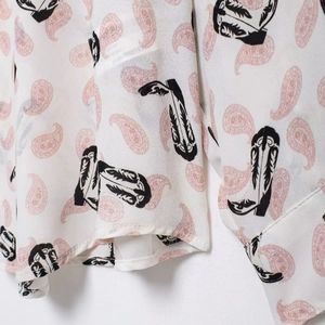 Vintage white shirt featuring pink paisley and black cowboy boot prints on fabric