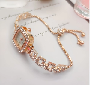 Detail of rose gold square watch featuring diamond-set bezel and adjustable slider chain