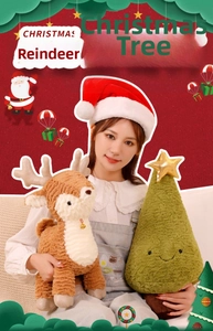 Close-up of a plush green Christmas tree pillow with smiley face and golden star top