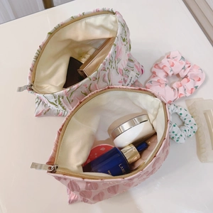 Pink heart and floral canvas makeup bags with metal zippers and interior storage view