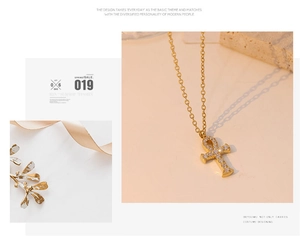 Detailed close-up of gold Ankh pendant necklace with sparkling cubic zirconia inlay crystals