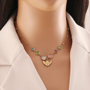Vintage gold bead necklace with colorful opal stones and angel bow pendant on model