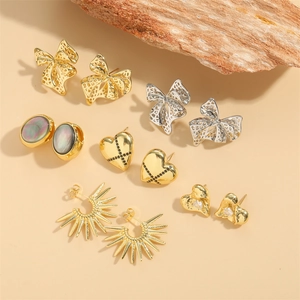 French vintage bow earrings set in gold and silver finish on wooden blocks