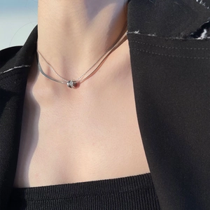 Double-layered silver titanium steel necklace with interlocking crystal rings on model