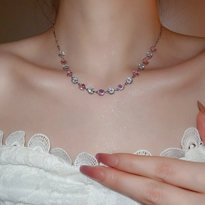Elegant choker necklace with pink and clear round cubic zirconia on a female neck