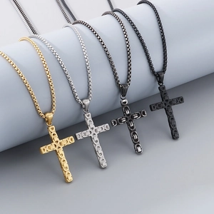 Detail of four punk-style cross necklaces in gold, silver, grey, and black stainless steel