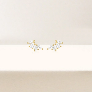 Detail of gold fan-shaped stud earrings with four sparkling marquise-cut crystals