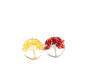 Detailed view of handmade Tree of Life pendants with natural crystals in gold and silver wire