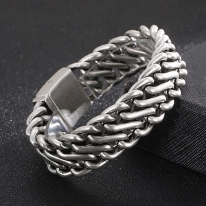 Detailed close-up of retro silver stainless steel woven bracelet with large square clasp