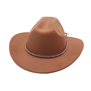 Detail of brown cowboy hat featuring rows of small rhinestones and gold studs on band
