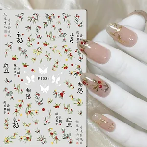 Detailed view of red bean pattern nail art stickers with elegant calligraphy and leaves