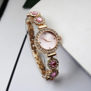Elegant gold quartz bracelet watch for women with pink dial and rhinestone encrusted bezel