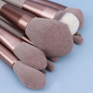 Macro detail of high-quality makeup brushes with soft bristles and rose gold metal ferrules