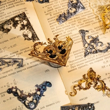 Macro view of vintage metal corner protectors with intricate floral vine patterns
